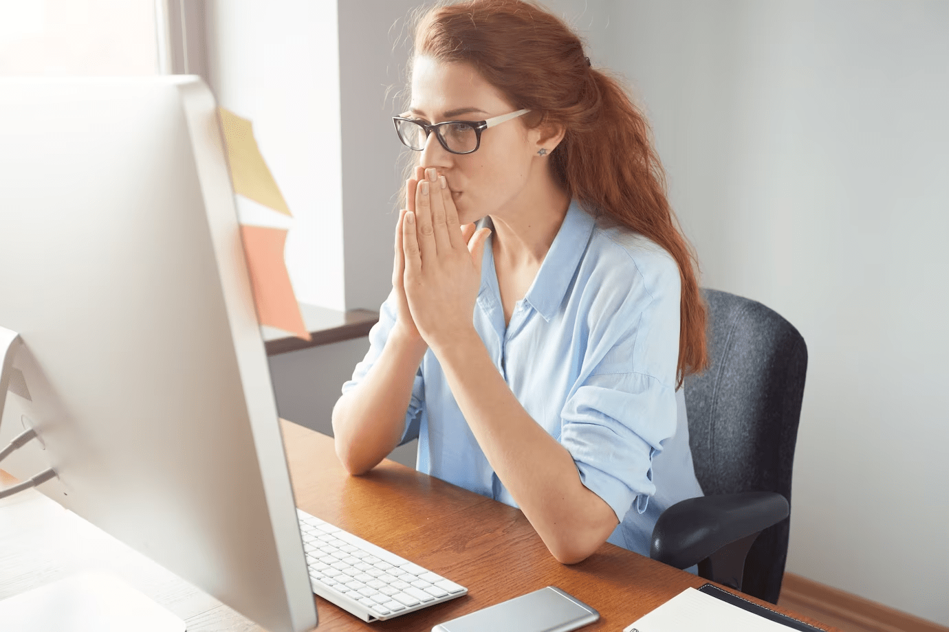 worried woman looking at a computer